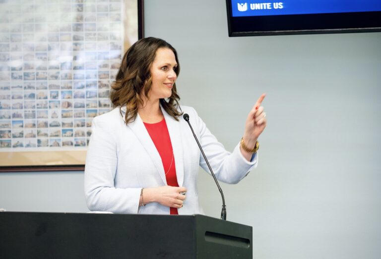 Mary Bier speaking at podium